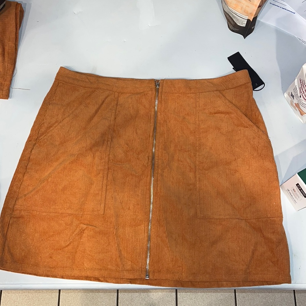 Burnt orange high waisted mini skirt. NWT never worn. Size Large and XLarge